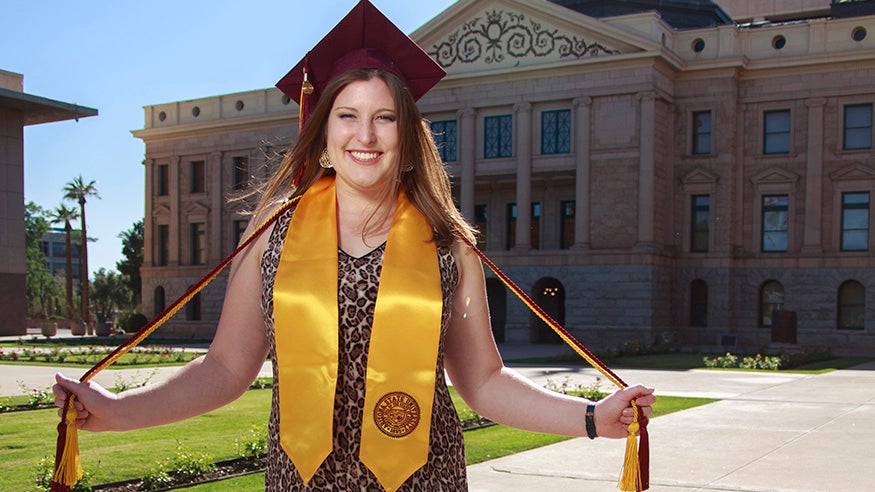  spring 2019 ASU graduate in front of the Arizona state capitol building