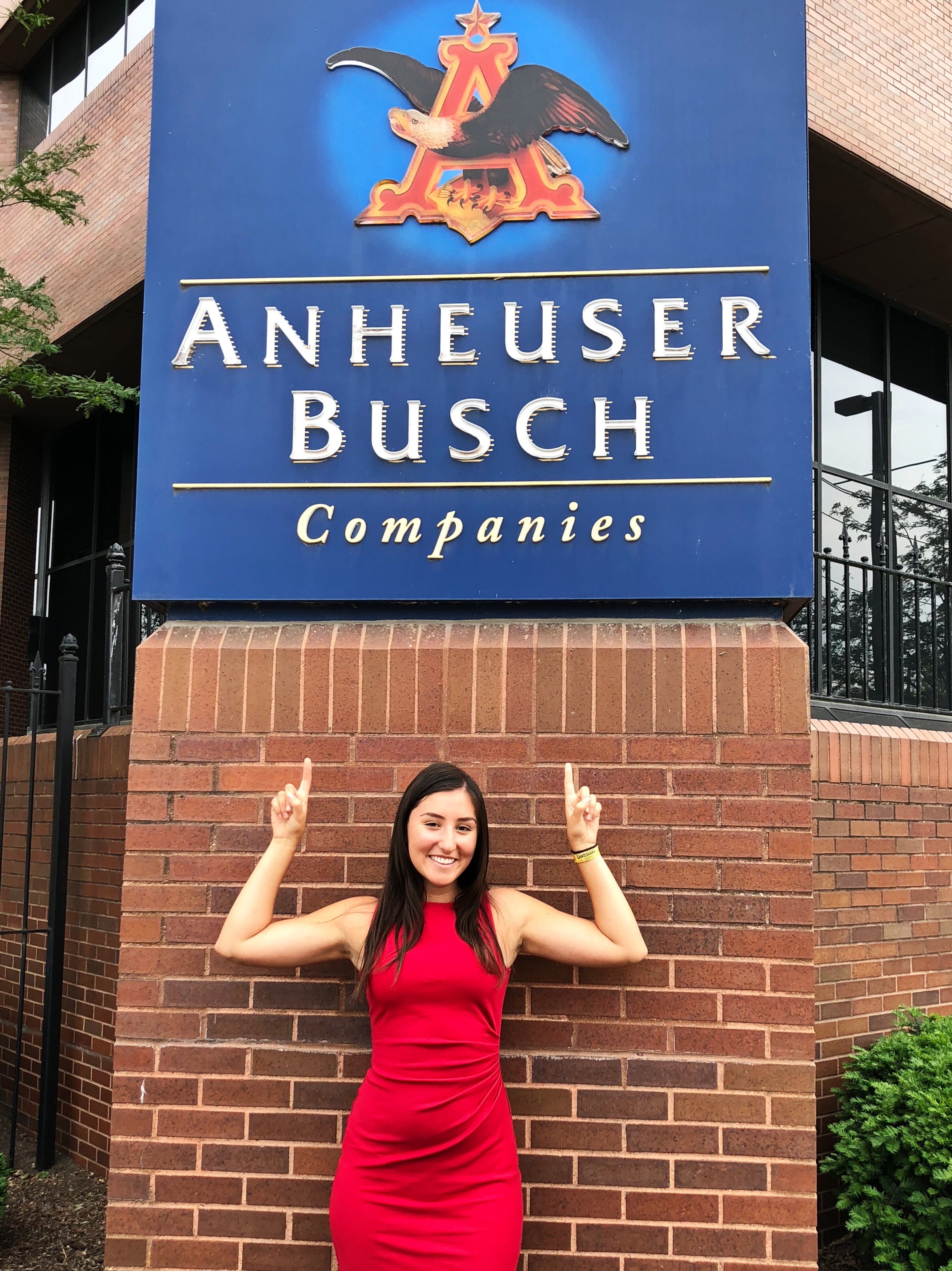  pointing at an Anheuser-Busch logo