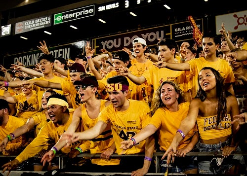 ASU Inferno student section students throw pitchforks at a football game