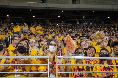 Students cheering wearing gold at 