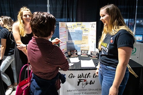 ASU students talking around a poster board