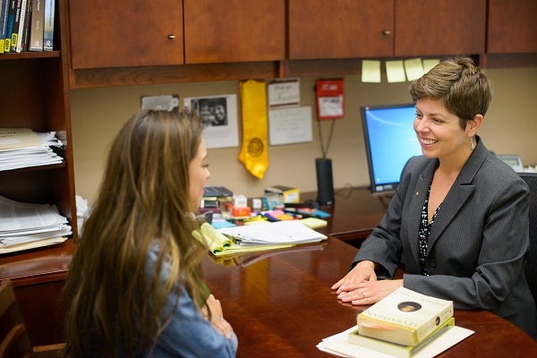 A student and a professional at a desk