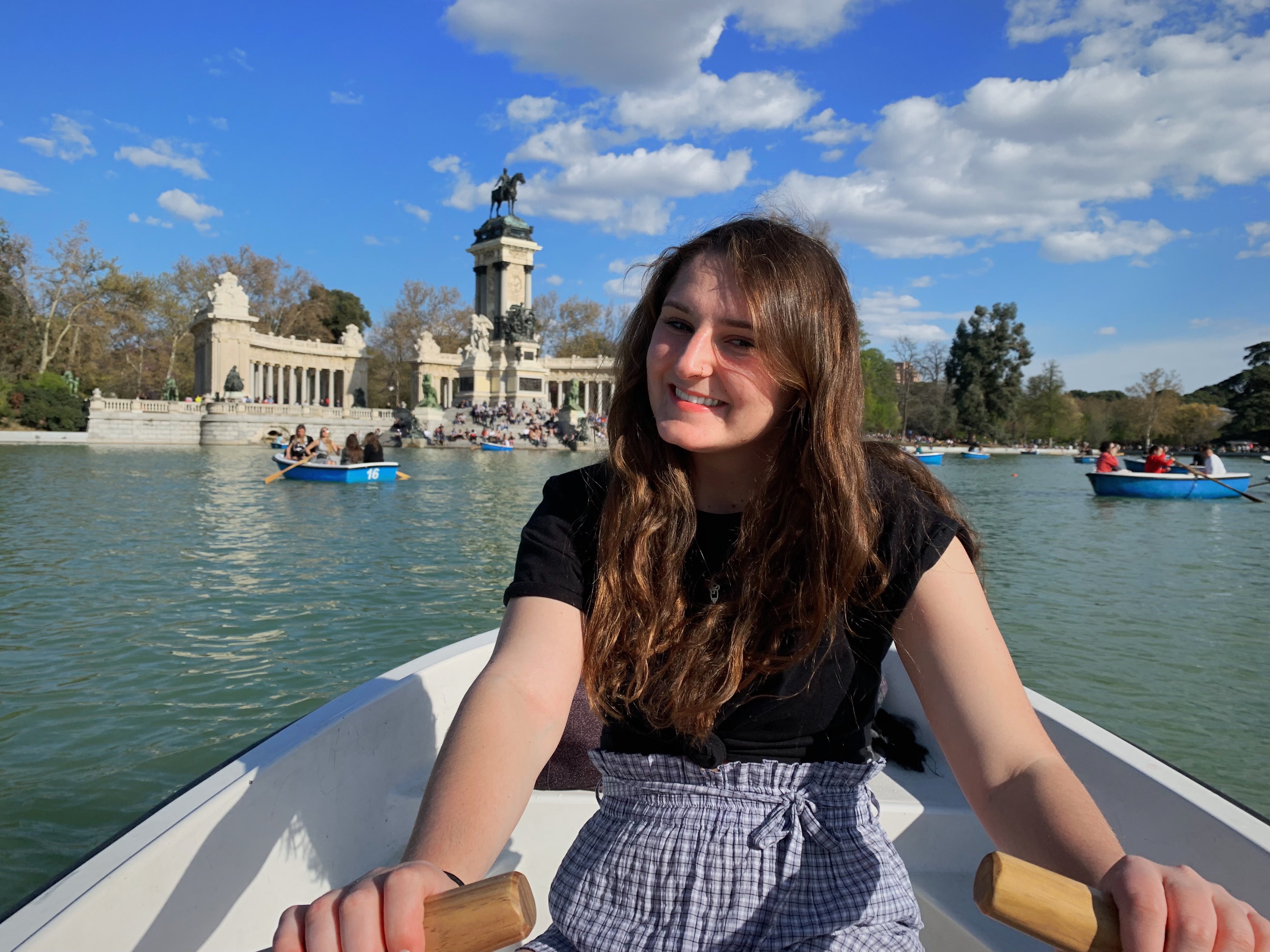 Student Julianna Drambarean sits in row boat and poses. 