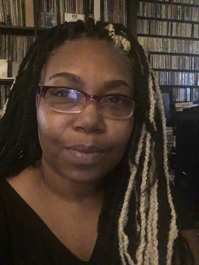 Priscilla Searcy in front of bookshelves