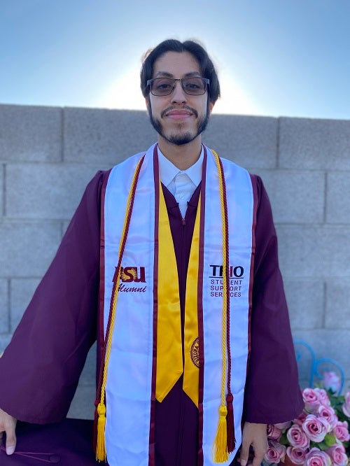 Rogelio Garcia in his ASU graduation gown and TRIO stole